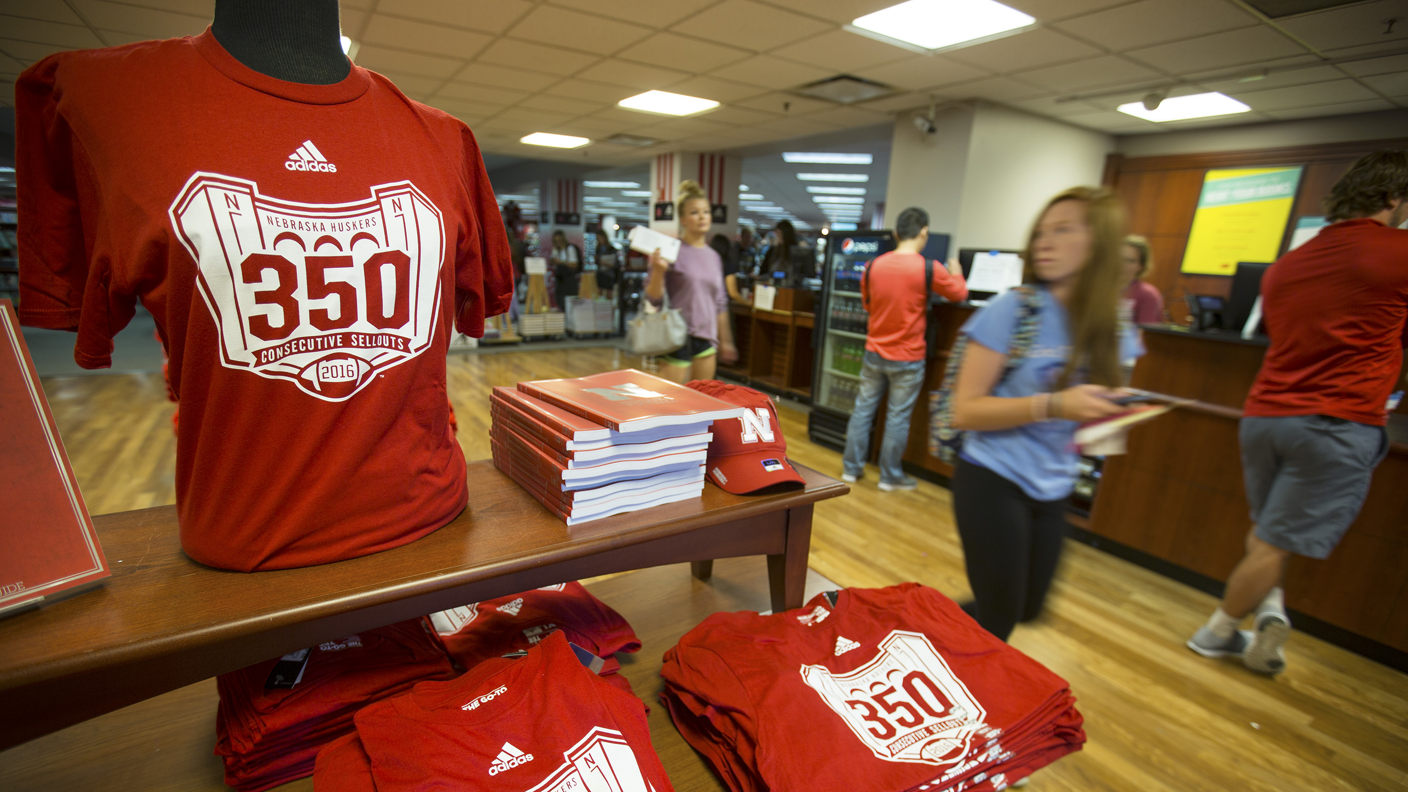 interior of the unl bookstore with students walking and carrying books